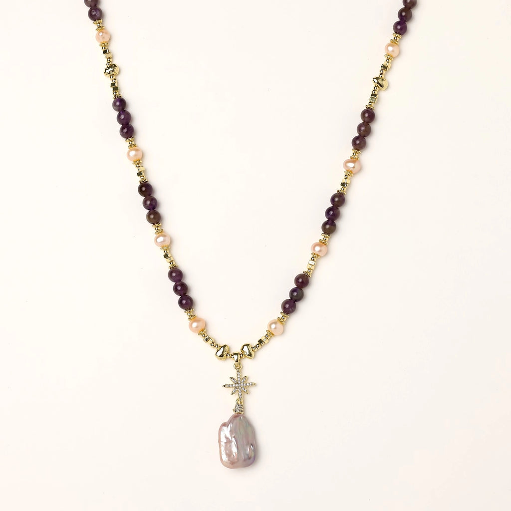 Gold-plated necklace with purple amethyst beads, pink pearls, and iridescent baroque pearl pendant beneath crystal star charm