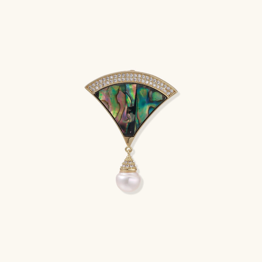 Art Deco fan-shaped pin with iridescent abalone shell, gold setting with crystals, and freshwater pearl drop.