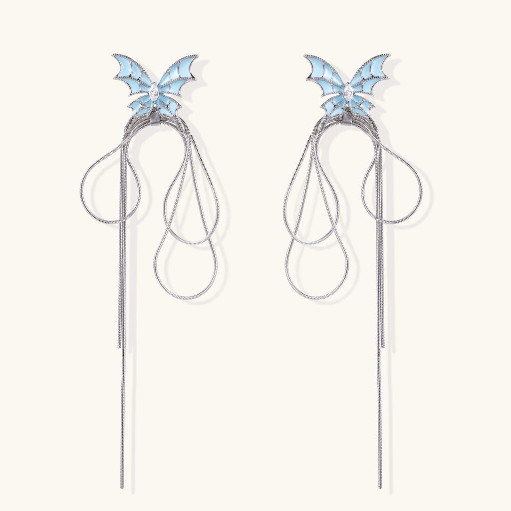 Blue enamel butterfly earrings with cascading gold-plated chains and zirconia crystal accents on white background.