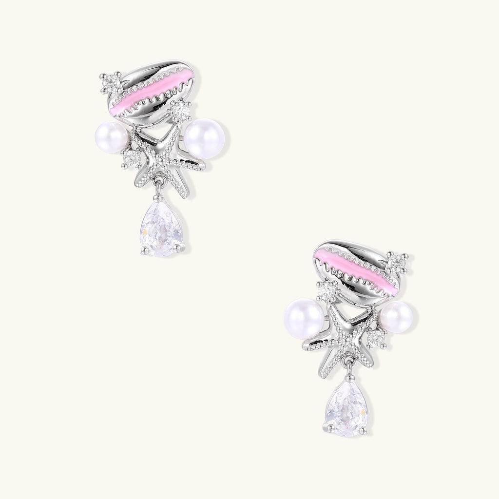 Gold-plated dangle earrings with enamel shell charms, white pearls, starfish accents, and crystal drops on white background.