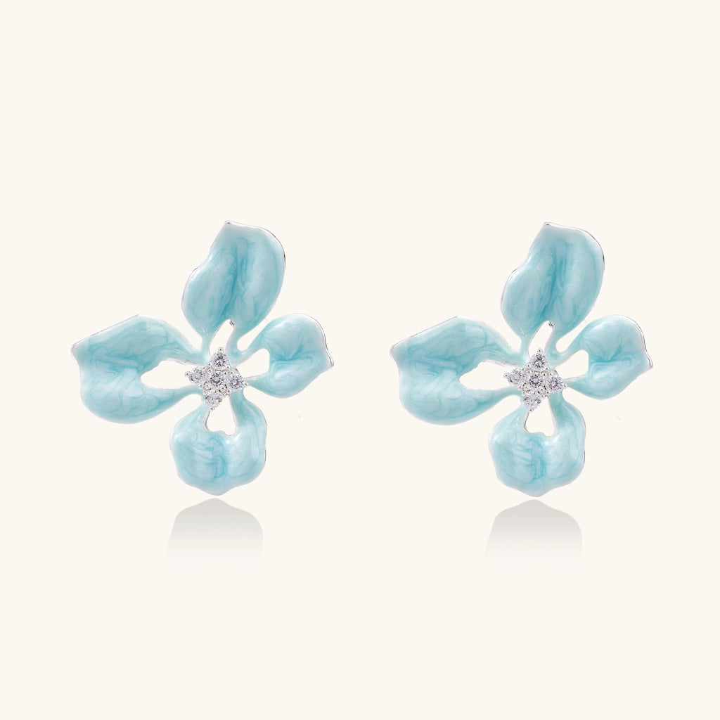 Turquoise blue enamel flower earrings with crystal centers and gold-plated brass posts on white background.