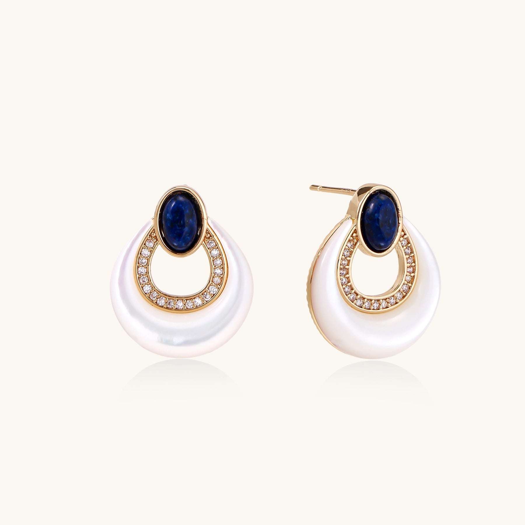 Gold-plated drop earrings featuring blue lapis lazuli ovals, diamond-studded circles, and iridescent mother of pearl teardrops