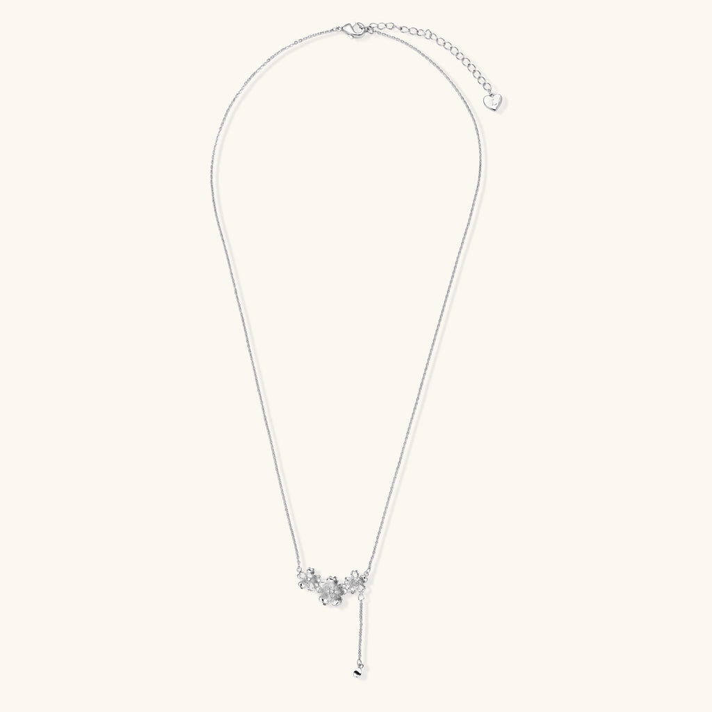 Delicate Y-style necklace with three textured flower pendants and adjustable chain in 14K gold plated brass finish.