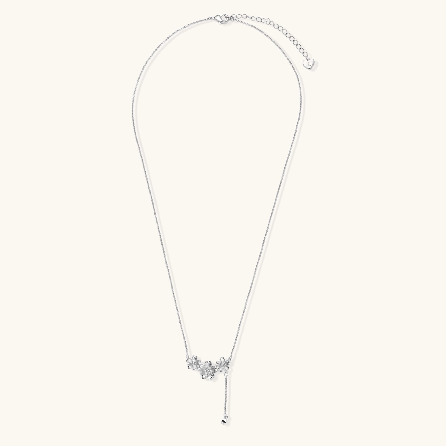 Delicate Y-style necklace with three textured flower pendants and adjustable chain in 14K gold plated brass finish.