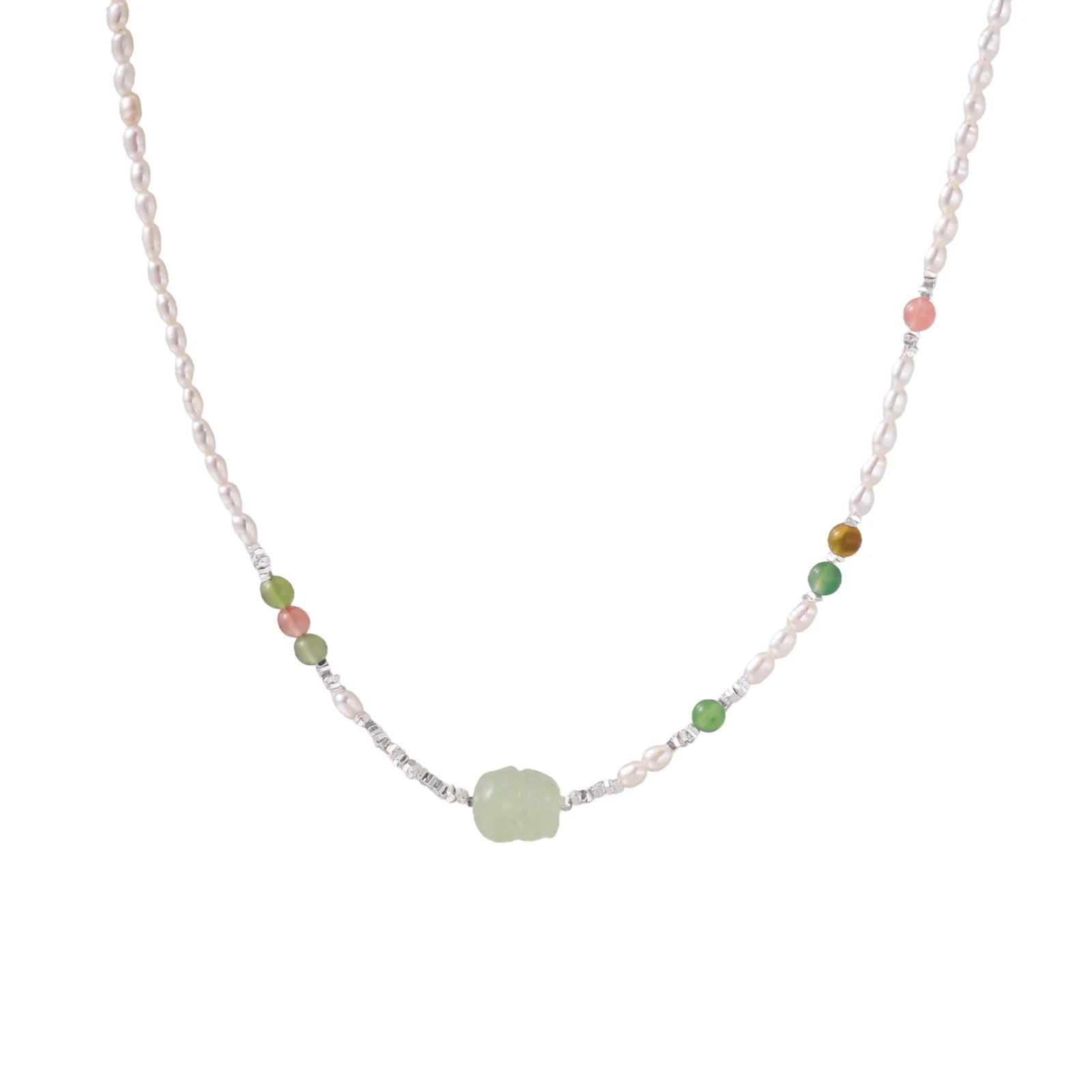 Delicate pearl necklace with pale green serpentine jade centerpiece and colorful agate beads on cream background