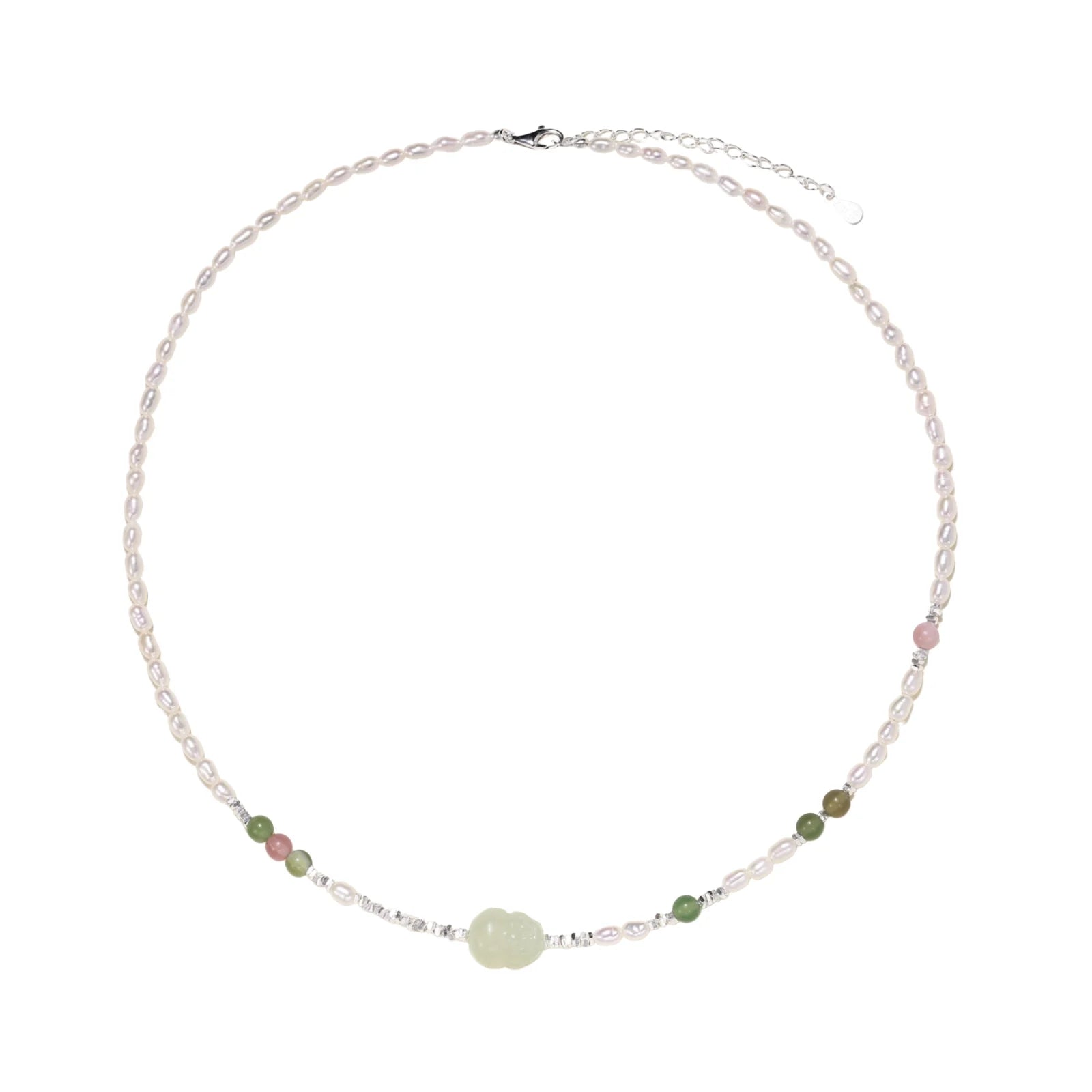 Delicate pearl necklace with pale green serpentine jade centerpiece and colorful agate beads on cream background