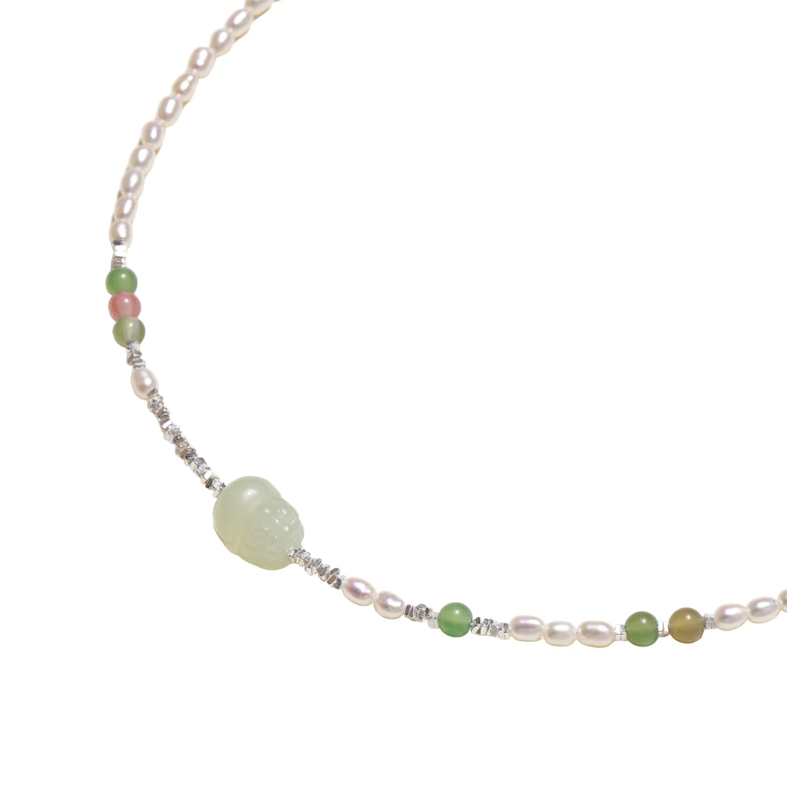 Delicate pearl necklace with pale green serpentine jade centerpiece and colorful agate beads on cream background