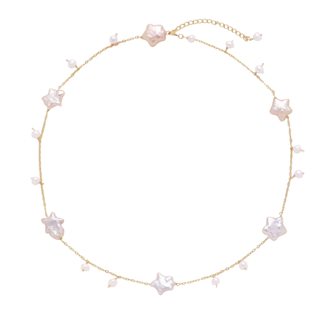 Gold vermeil chain with iridescent star-shaped baroque pearls and small round freshwater pearl drops on cream background.