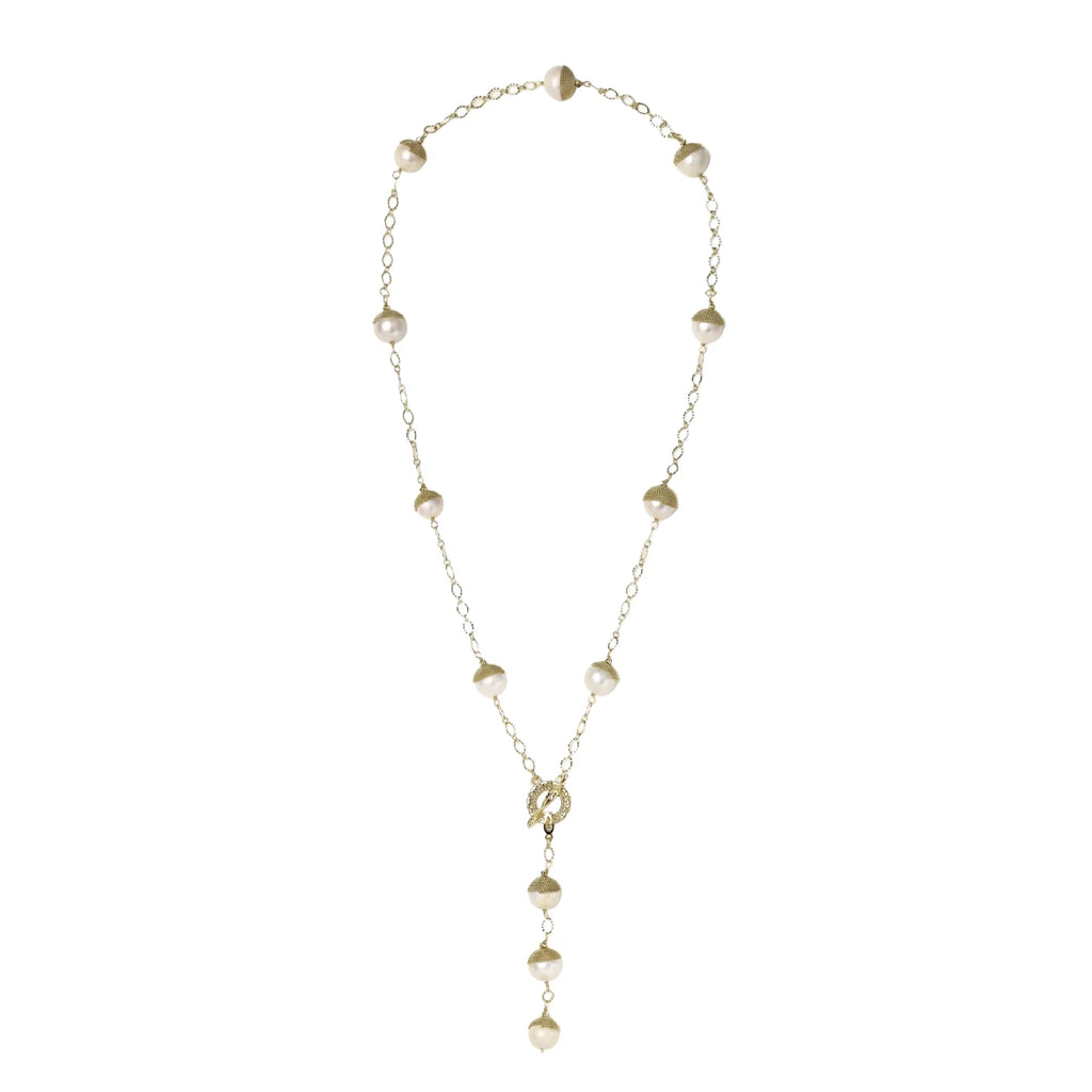 Gold-plated lariat necklace with baroque pearls and textured caps on cream background, showing adjustable Y-shaped design.
