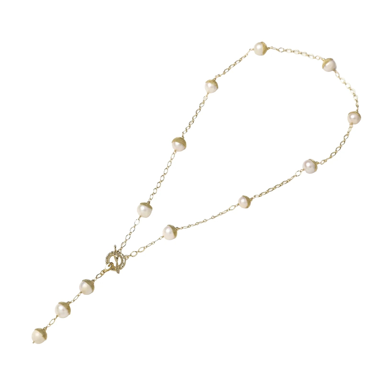 Gold-plated lariat necklace with baroque pearls and textured caps on cream background, showing adjustable Y-shaped design.