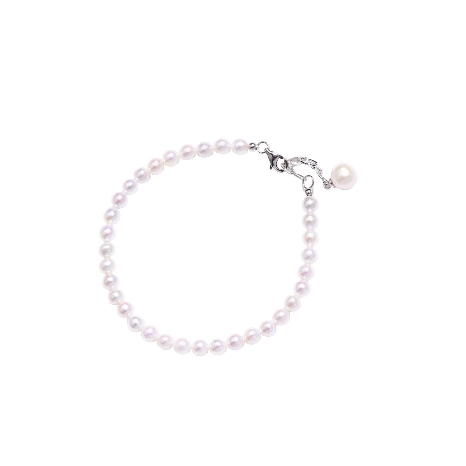 Delicate freshwater pearl bracelet with rhodium-plated silver clasp and single pearl drop charm on cream background