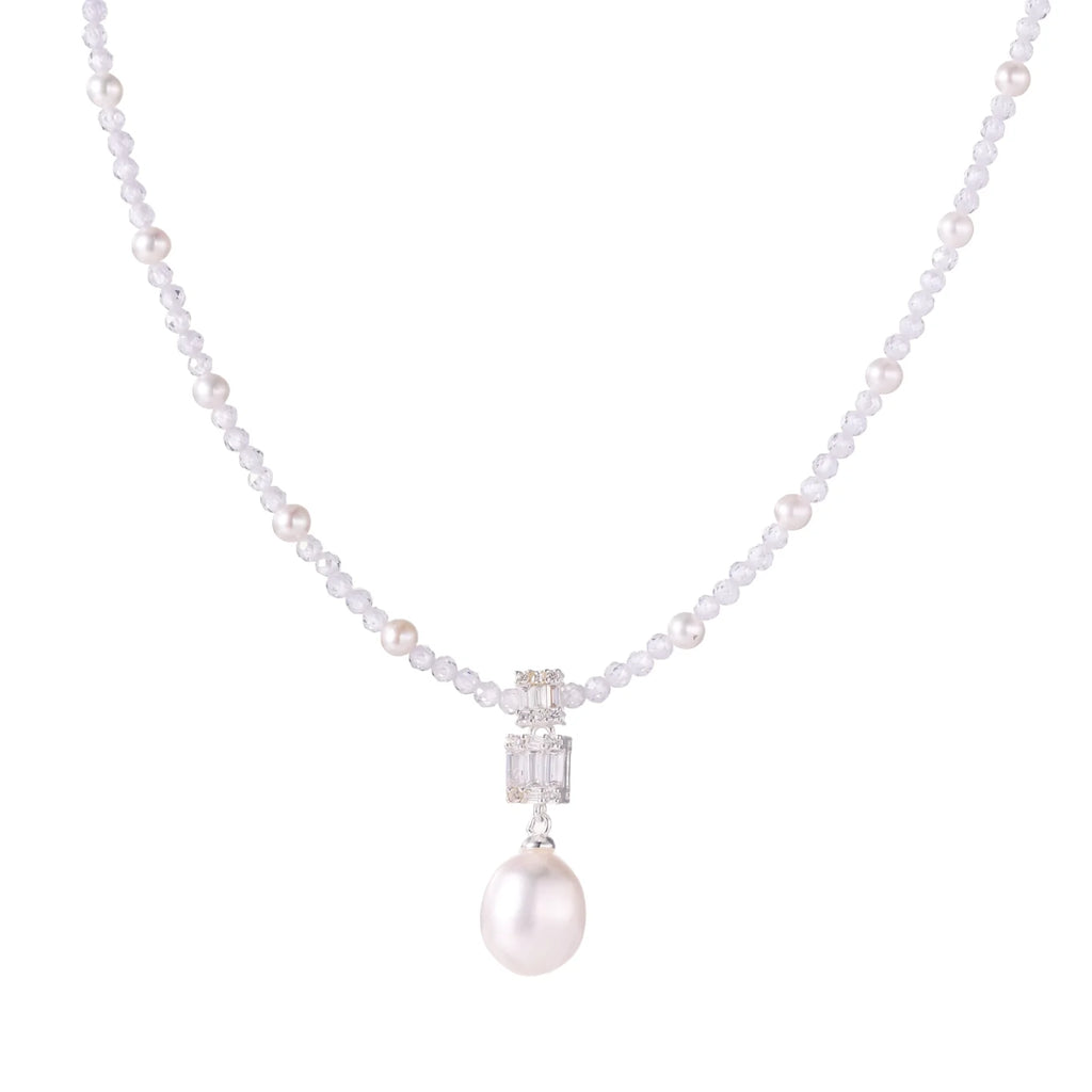 Dainty necklace with lavender crystal beads, freshwater pearls, geometric pendant, and large pearl drop on white background.