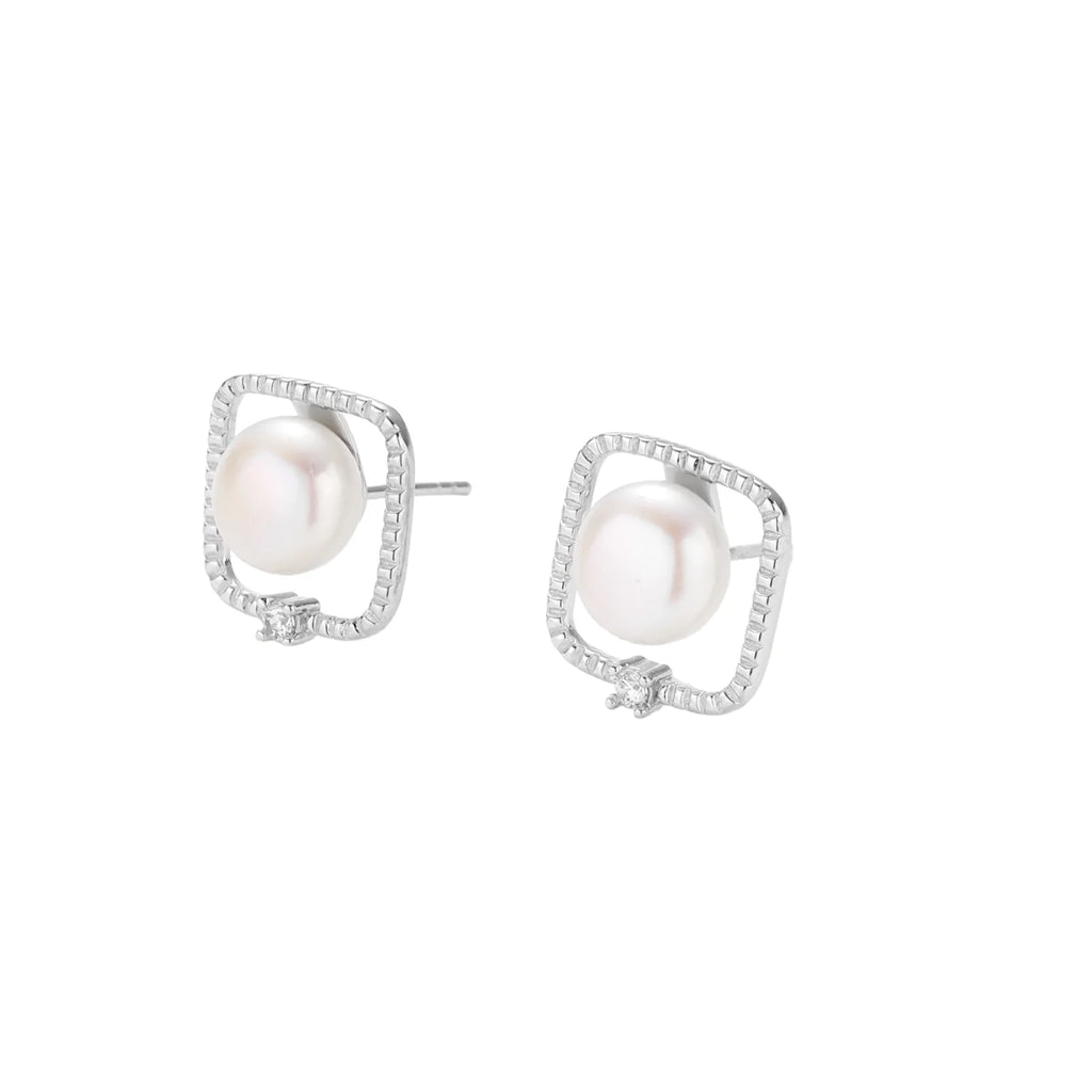 Rhodium-plated silver stud earrings with cushion frame, centered freshwater pearl, and tiny crystal accent