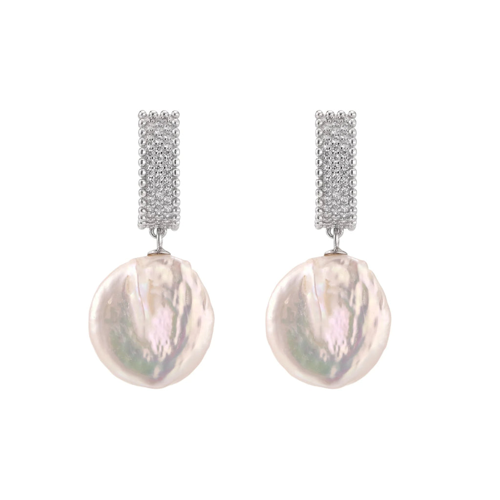 Rhodium-plated silver curved stud with pave stones and baroque pearl drop on white background