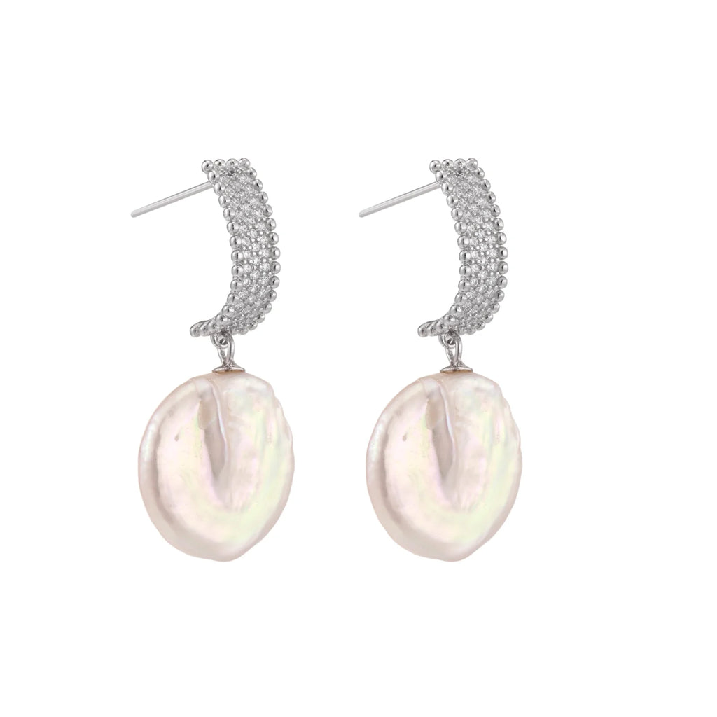 Rhodium-plated silver curved stud with pave stones and baroque pearl drop on white background
