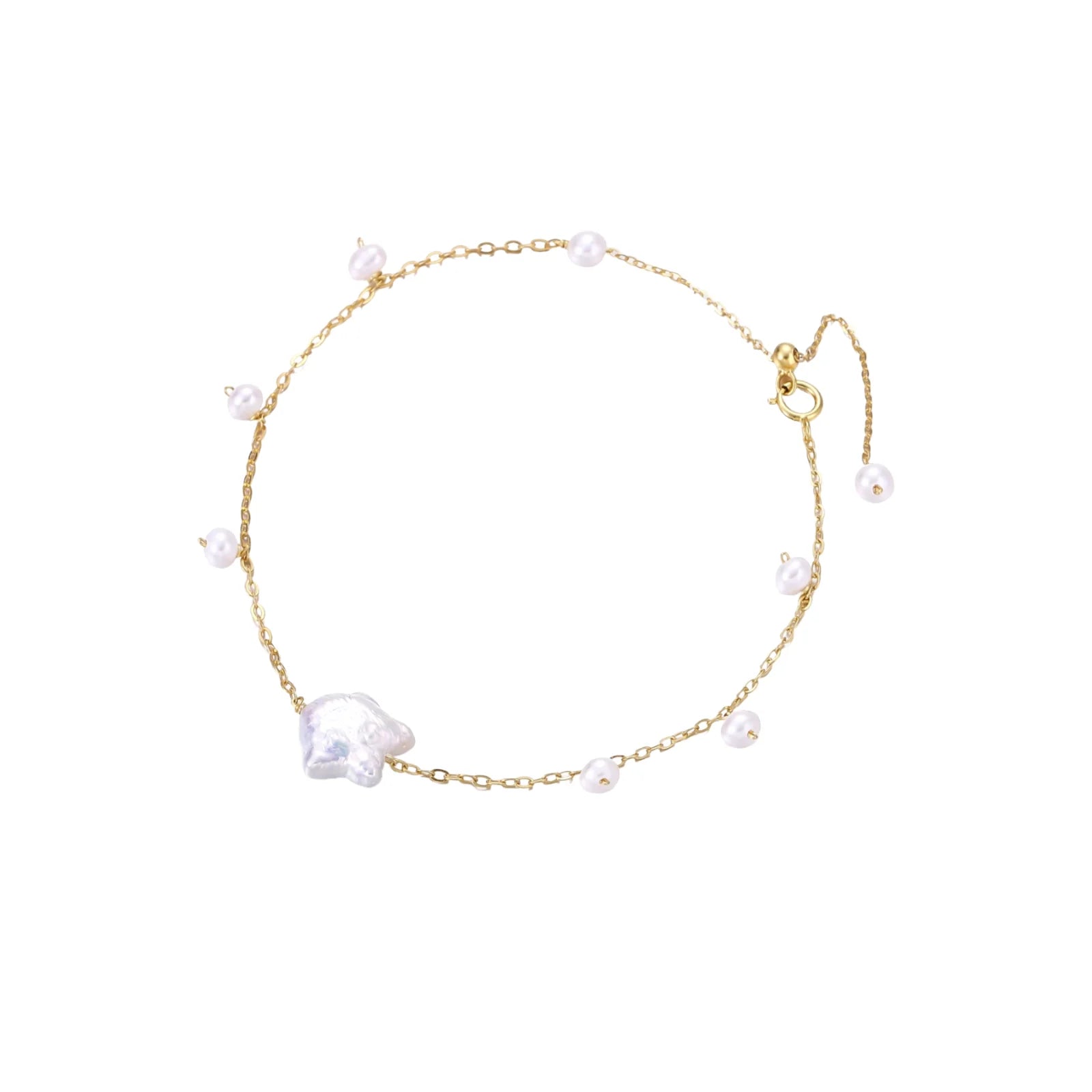 Delicate gold chain bracelet with baroque pearl centerpiece and small freshwater pearls on cream background.