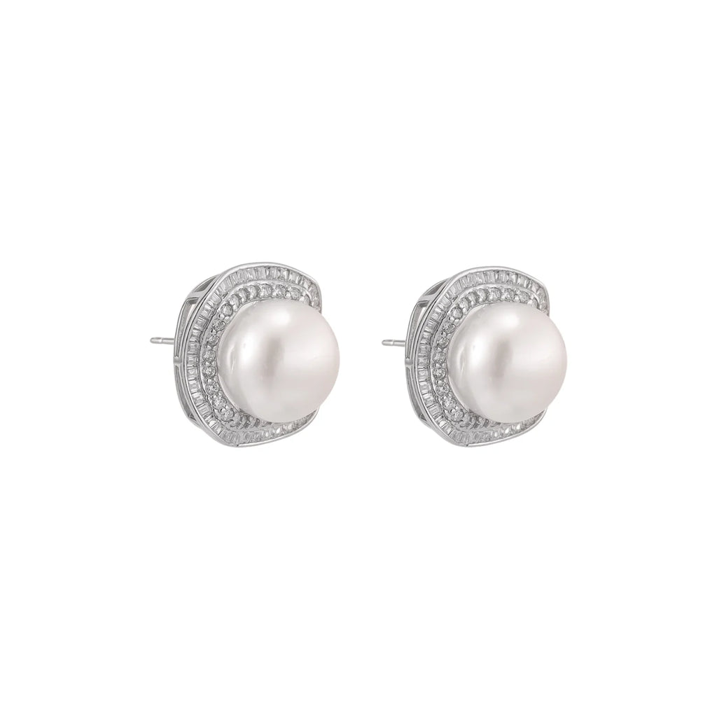 Cushion-shaped sterling silver stud earrings with freshwater pearls surrounded by geometric diamond halos