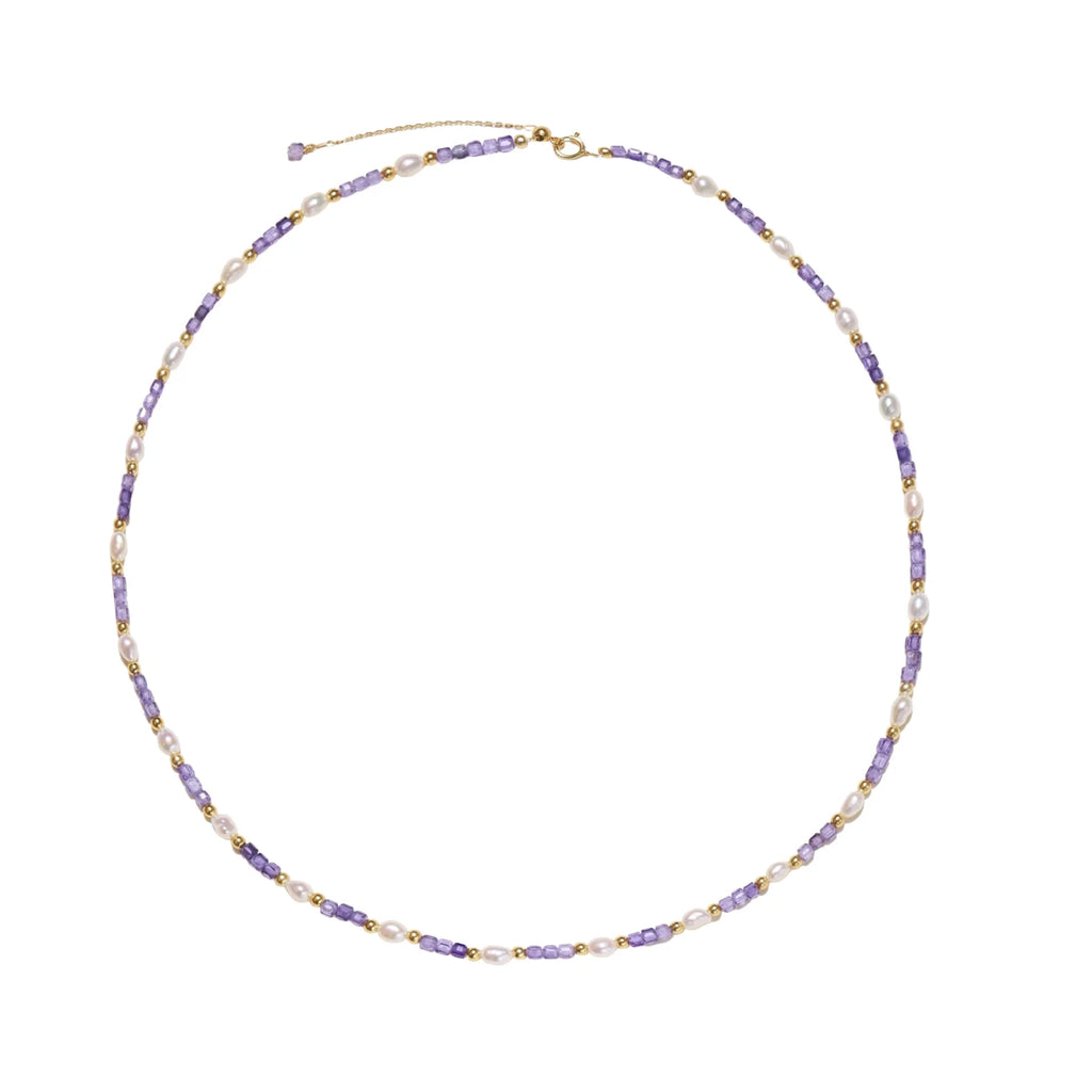 Delicate 18K gold vermeil necklace with alternating lavender zirconia beads and white freshwater pearls on cream background