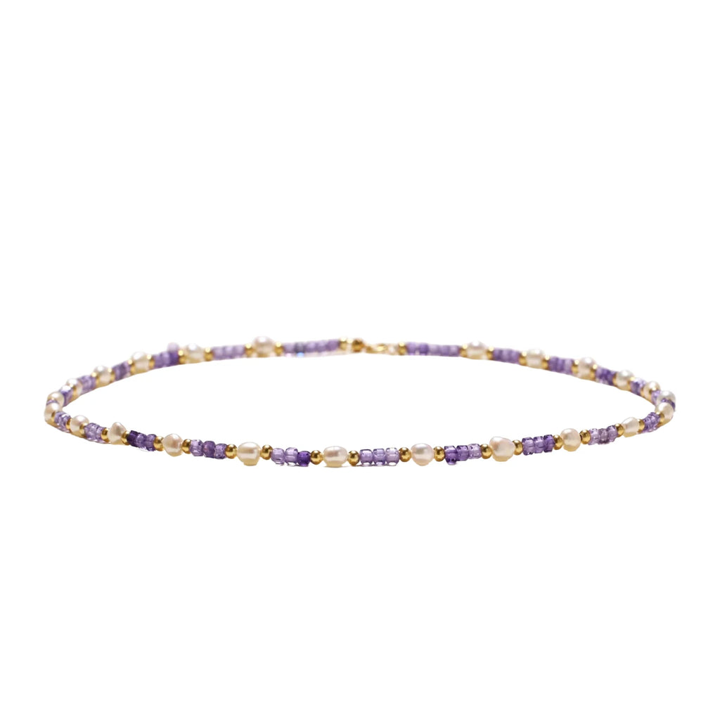 Delicate 18K gold vermeil necklace with alternating lavender zirconia beads and white freshwater pearls on cream background