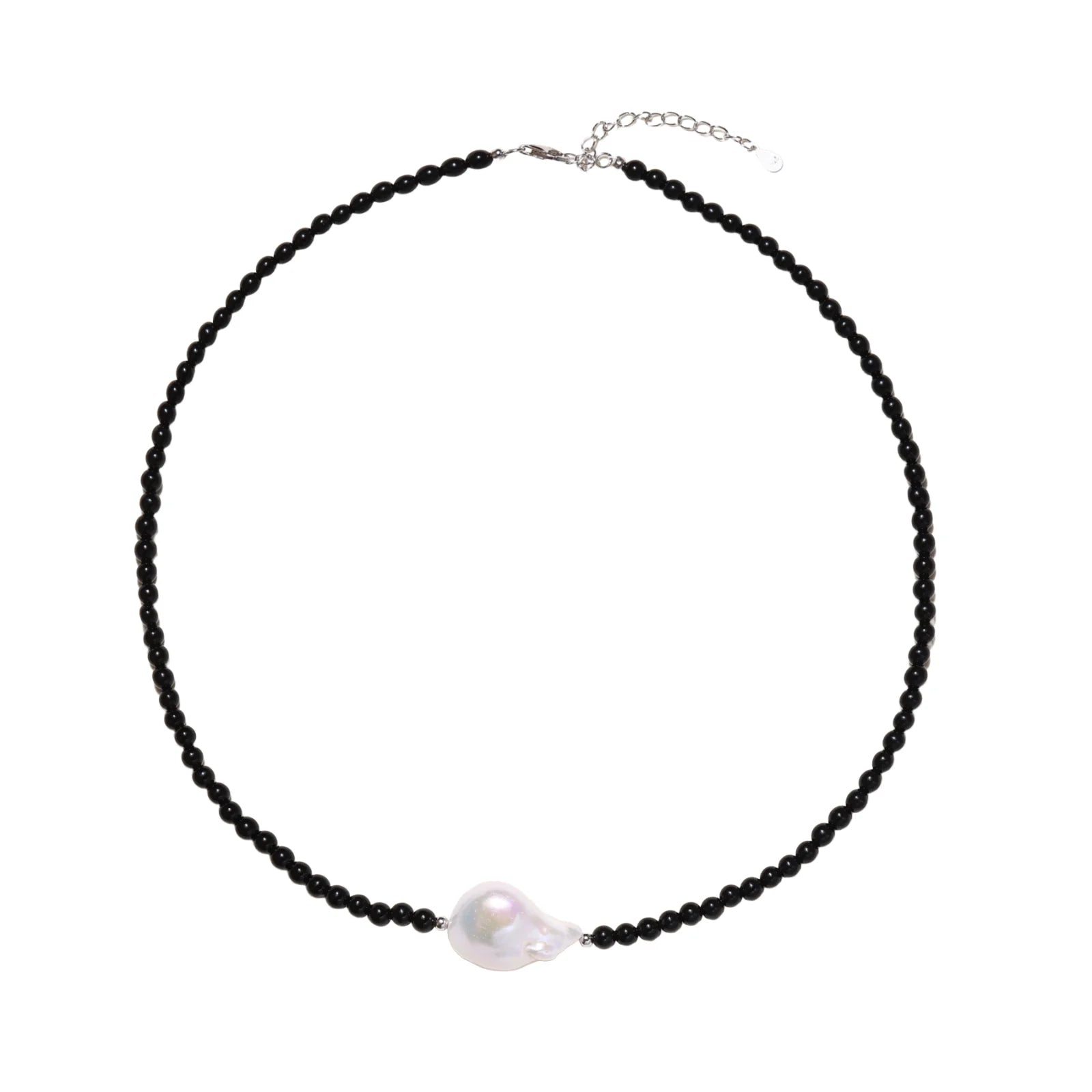 Beaded black agate necklace with iridescent baroque freshwater pearl centerpiece on cream background.